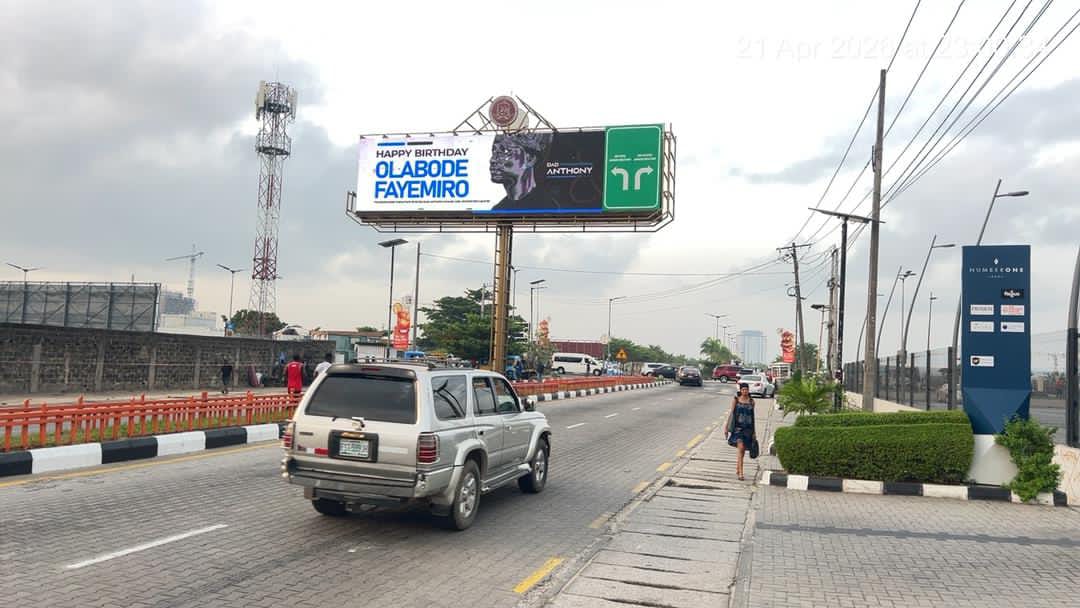 A digital outdoor screen viewed from a busy Lagos road