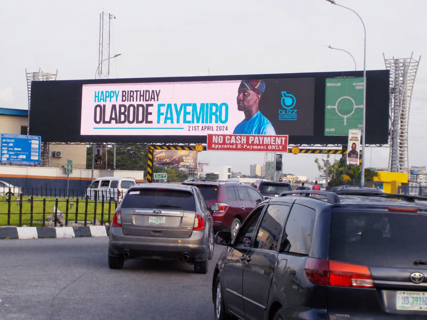 A digital billboard above a busy Lagos road