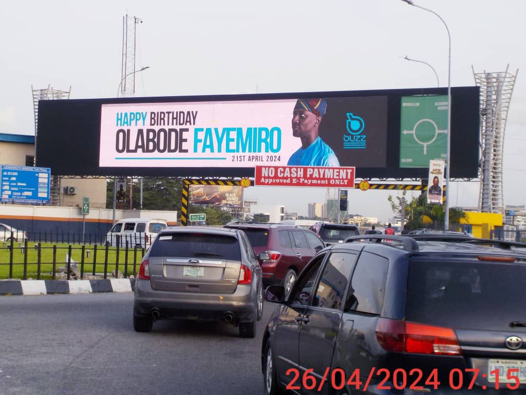 A digital billboard above a busy Lagos road